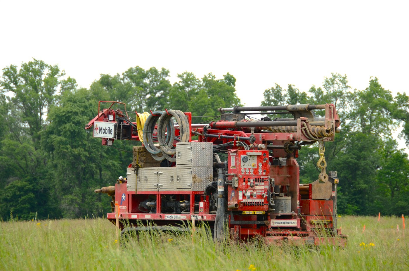 Tracked drill rig in a field